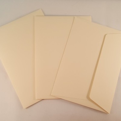 Quatro envelopes cor creme em diferentes posições sobre uma superfície clara