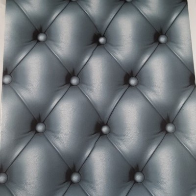 material cinzento com padrão capitonê em relevo e botões embutidos