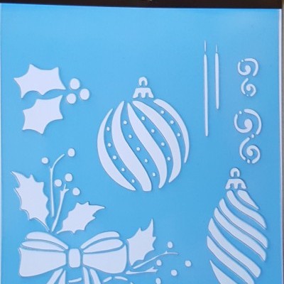 Stencil azul com motivos de Natal recortados, embalagem preta com texto ATILA FOR HOBBY STENCIL