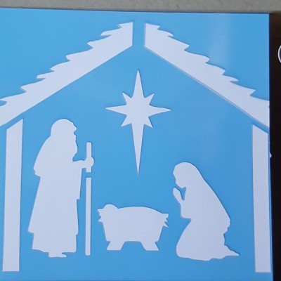 Stencil azul com figuras brancas da manjedoura e embalagem preta com texto ATILA STENCIL