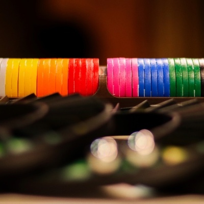 Colorful poker chips in a black plastic rack on a table