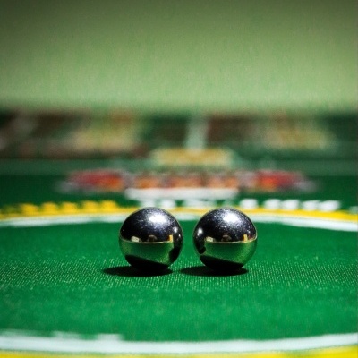 Two metal balls on green casino table