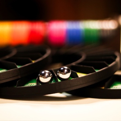 Metallic balls in black segmented tray with colorful background