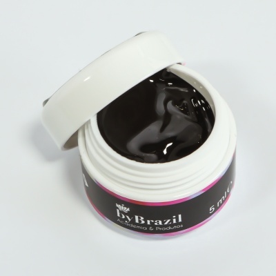 Frasco pequeno branco com produto preto cremoso aberto