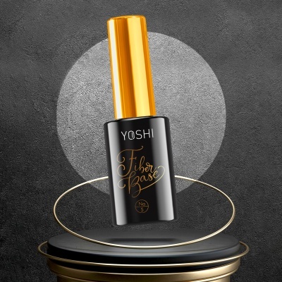 Frasco de verniz para unhas YOSHI Fiber Base Nº3 preto e dourado num pedestal