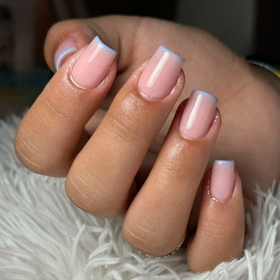 Manicure francesa com base rosa clara e ponta azul claro em unhas femininas