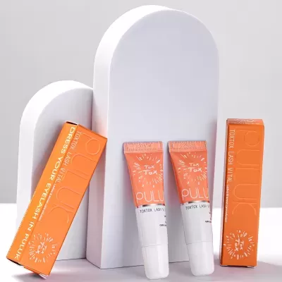 Produtos TOXTOR LASH VITAL cor de laranja sobre suportes brancos curvos