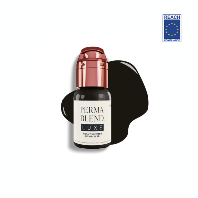 Frasco pequeno escuro com tampa cobre e rótulo branco, com selo REACH compliance ao fundo