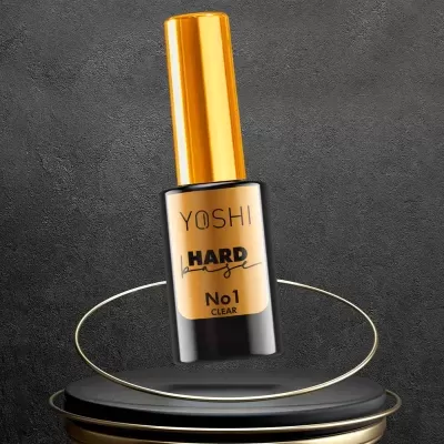 Frasco de verniz de unha YOSHI Hard No 1 Clear sobre suporte preto e dourado