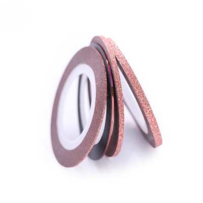 Três rolos de fita dupla face rose gold brilhante