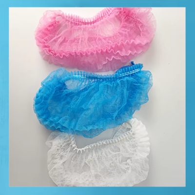 Toucas descartáveis rosa, azul e branca em tecido não tecido