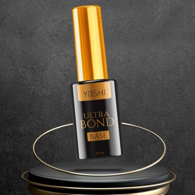 Frasco de verniz YOSHI Ultra Bond Base 10 ml preto e dourado numa base negra com detalhes dourados