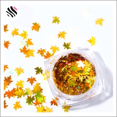 Glitter dourado em forma de folhas dentro de recipiente transparente
