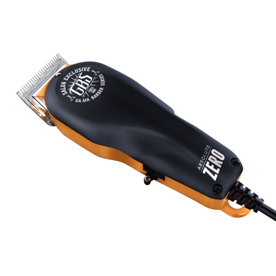 Máquina de cortar cabelo preta e dourada com inscrições e lâmina metálica