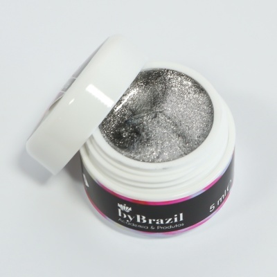 Pote branco com gel prateado brilhante e rótulo preto com texto