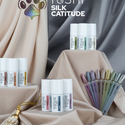 Frascos de verniz YOSHI com amostras coloridas e tecidos de fundo em bege e cinza.