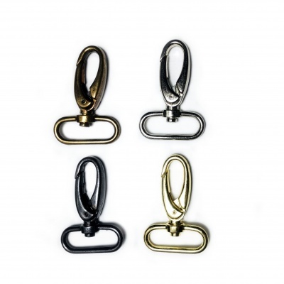 Quatro mosquetões metálicos de cores diferentes sobre fundo branco