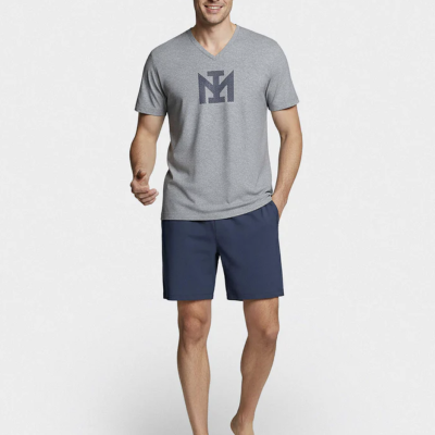 Homem com t-shirt cinzenta e calções azul escuro
