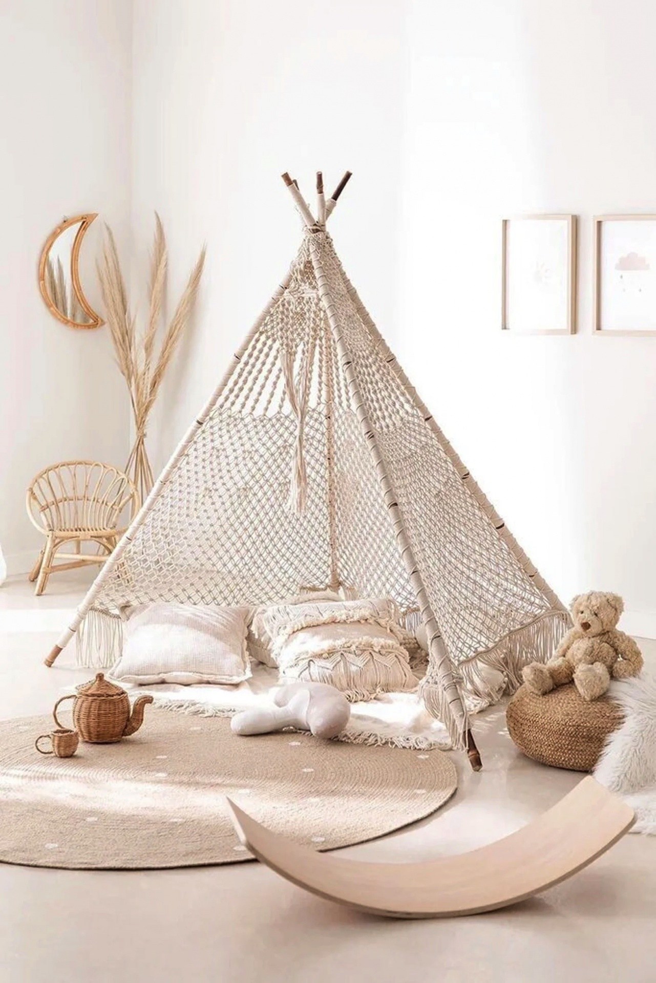 Tenda branca em crochê com almofadas e brinquedos numa decoração clara e natural