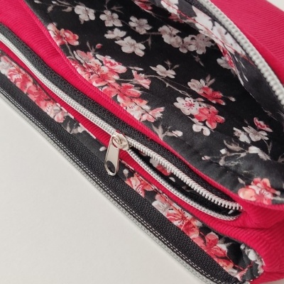 Estojo escolar vermelho com interior floral e fechos prateados