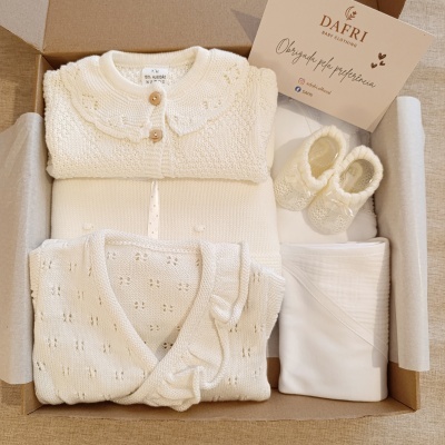 Caixa com roupa de bebé branca em malha de algodão e acessórios