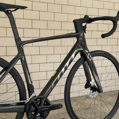 Bicicleta de estrada cinza escuro em pavimento de azulejos