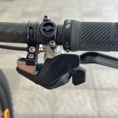 Punho e manete de mudança de velocidades de bicicleta num guiador preto