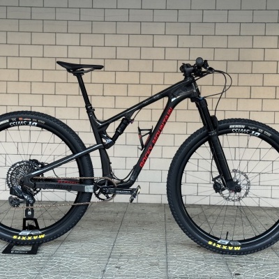 Bicicleta de montanha preta com texto ROCKY MOUNTAIN vermelha num fundo de azulejos