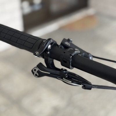 Punho e manete de bicicleta pretos com textura quadrada no punho e detalhes metálicos