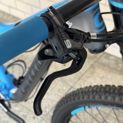 Guiador de bicicleta azul com punho azul e alavanca de travão preta com texto MAGURA 8 SX.