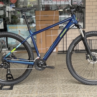 Bicicleta de montanha azul metálica com suspensão dianteira e travões de disco