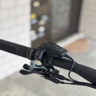 Guiador de bicicleta preto com componente Bosch e manetes metálicas