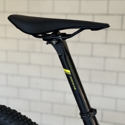 Assento preto de bicicleta com canote preto e texto amarelo