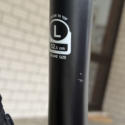 tubo preto metálico com etiqueta branca e texto sobre tamanho e posição