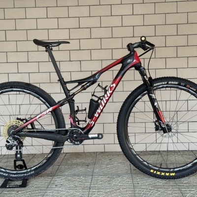 Bicicleta de montanha S-WORKS preta e vermelha com pneus Maxxis e Schwalbe