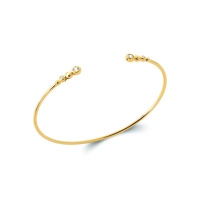 Pulseira aberta dourada com pequenos cristais