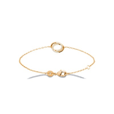 Pulseira dourada com pendente circular e pedrinhas brilhantes