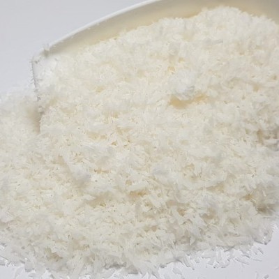 Colher branca com flocos brancos tipo coco ralado