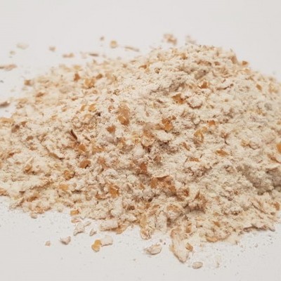 Pó ou flocos bege claro sobre superfície branca