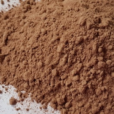 Pó castanho solto sobre superfície branca