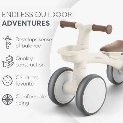 Bicicleta de equilíbrio infantil branca com rodas e punhos castanhos e texto ao lado