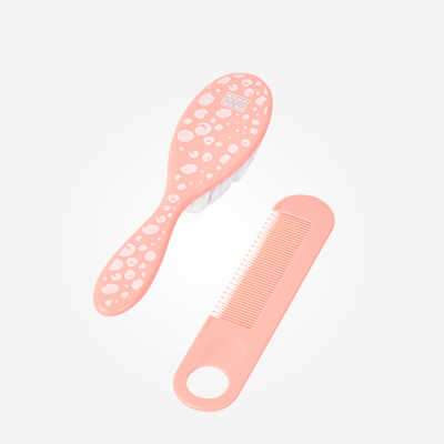 Pente e escova de cabelo cor de rosa com padrão branco e logótipo DE BÉBÉ