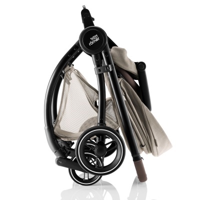 Carrinho de bebé dobrável bege com estrutura preta e texto 'baby jogger'