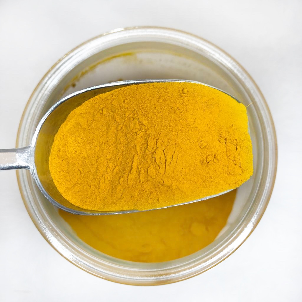 Curcuma Pó Bio GRANEL Pote de vidro com pó amarelo e colher metálica