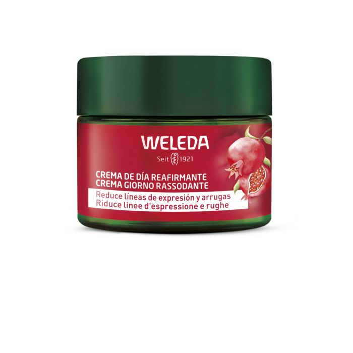 Frasco de creme de dia reafirmante Weleda vermelho com tampa verde escura e imagem de romã