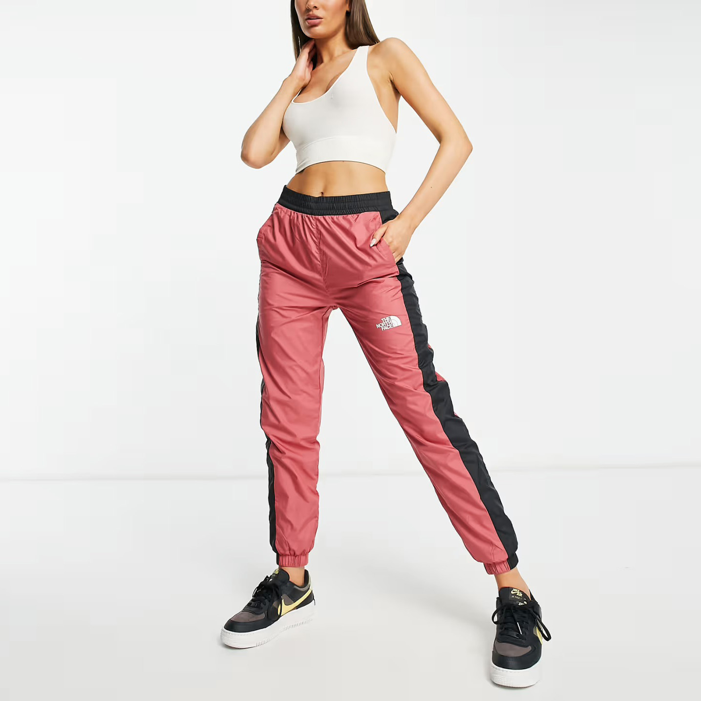 Calças desportivas rosa e pretas com logo THE NORTH FACE.
