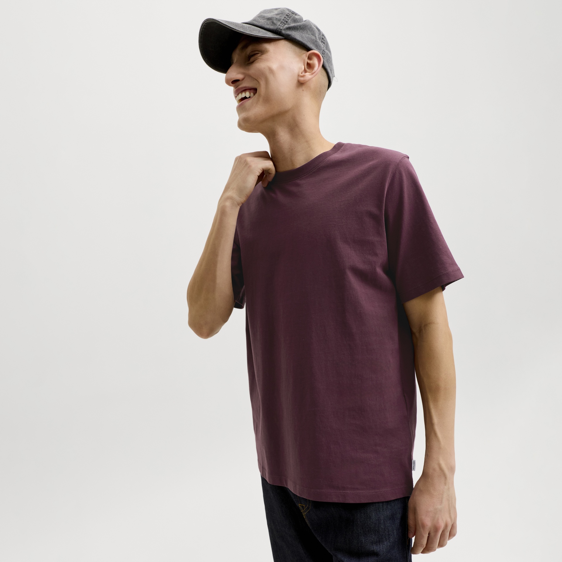 T-shirt masculina vinho de manga curta com calças jeans e boné cinza