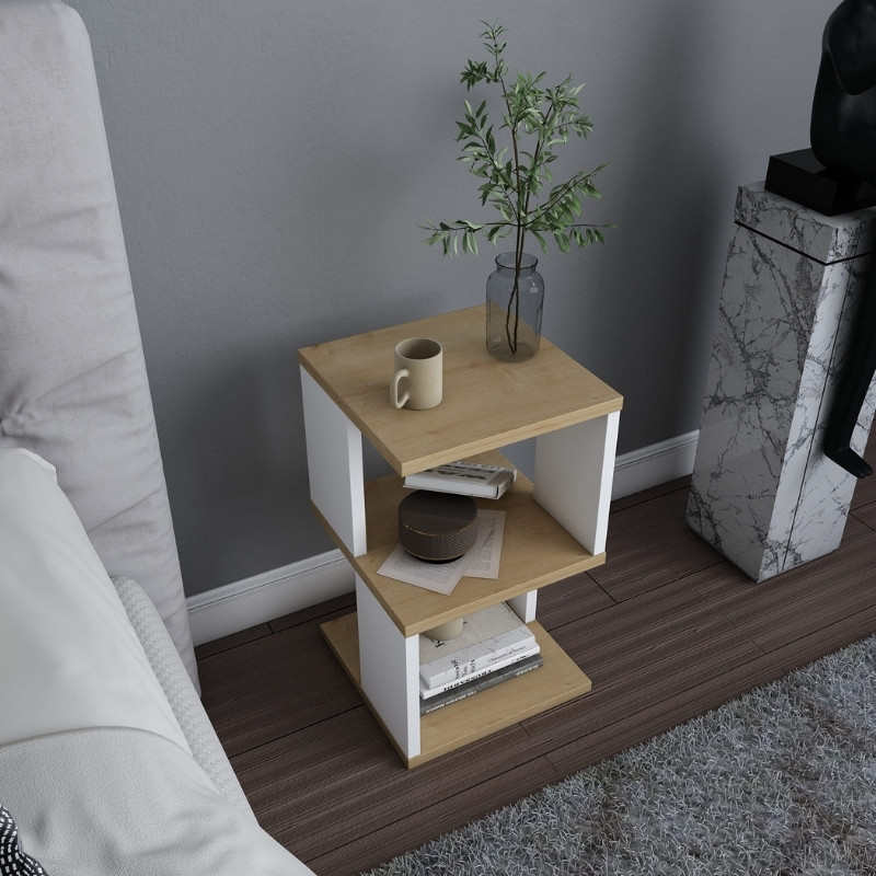 Mesa de apoio de madeira clara e branca com decoração e livros ao lado de sofá e tapete cinzento