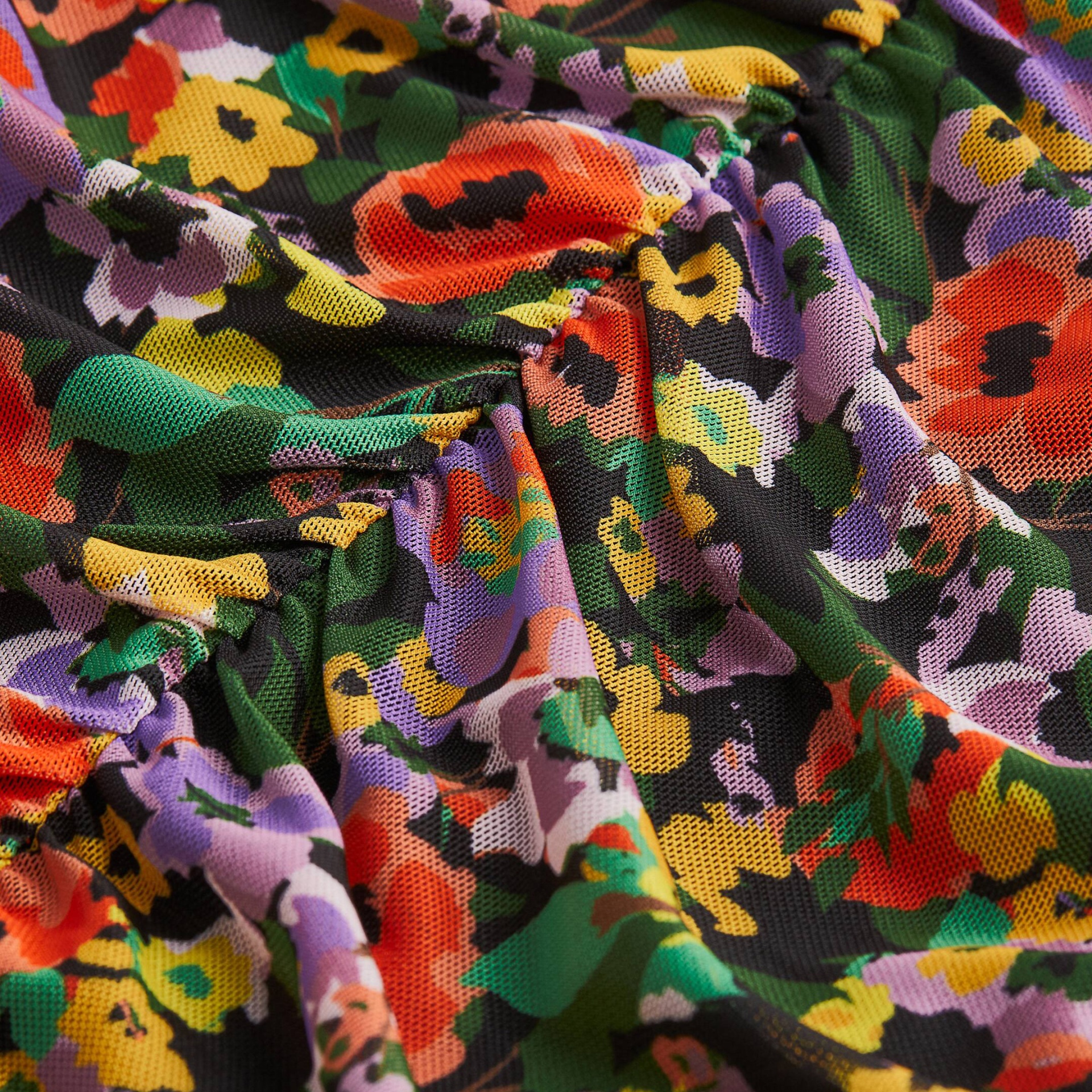 Tecido multicolorido com padrão floral e textura de malha