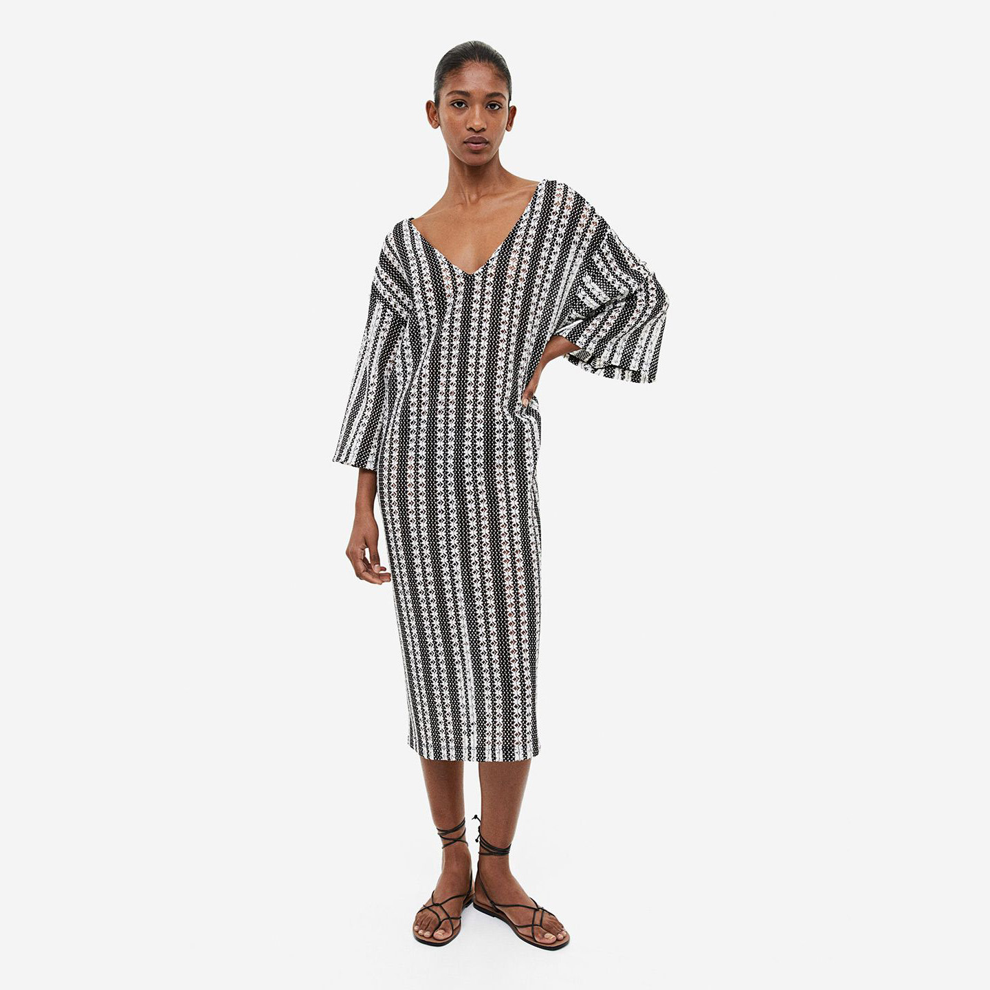 Vestido midi em malha com padrão preto e branco, com modelo e sandálias pretas